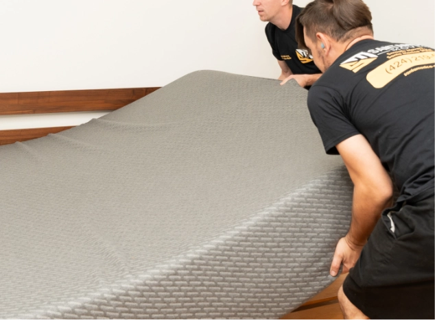 Movers lifting a mattress